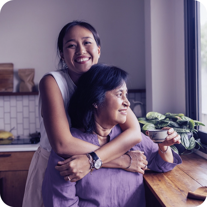 Smiling mother and daughter embracing