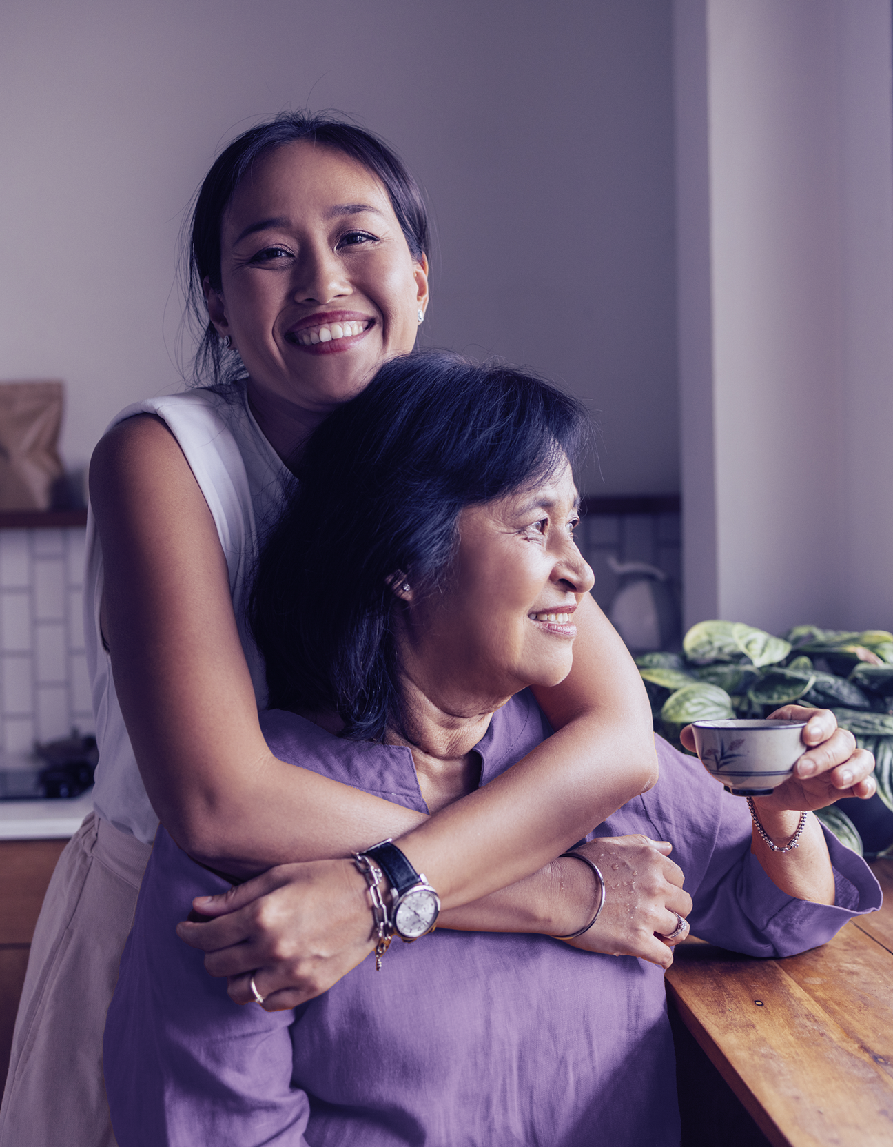 Smiling mother and daughter embracing